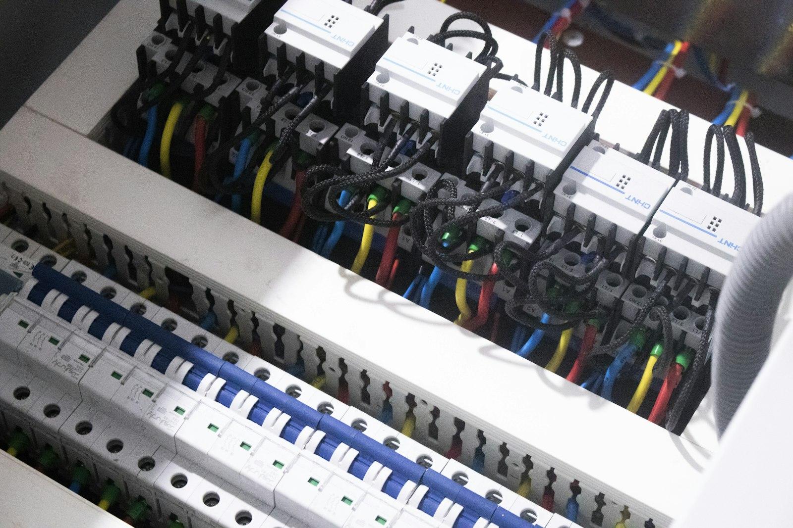 Contactors and circuit breakers wired inside an industrial control panel